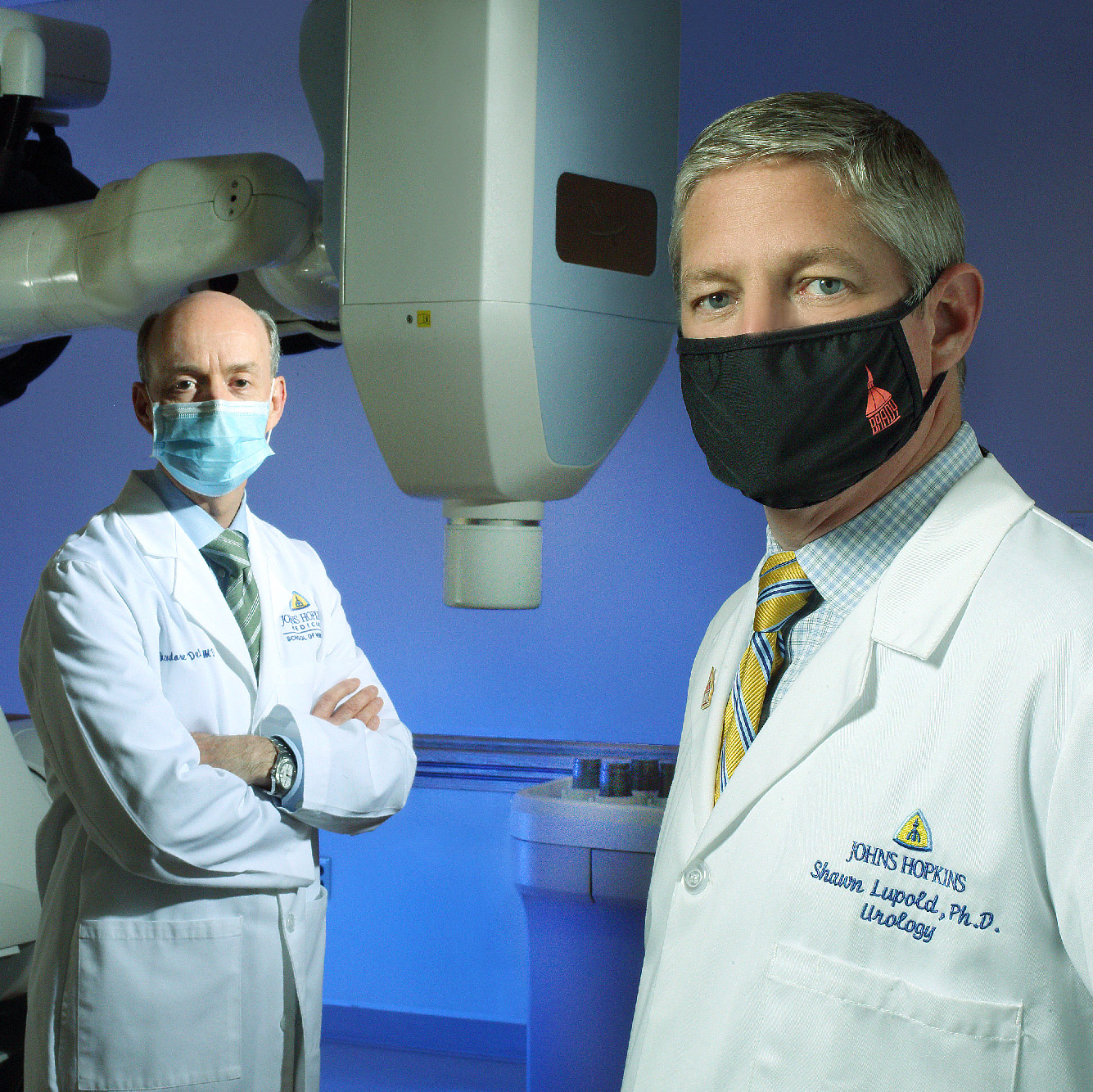 DeWeese and Lupold in front of medical technology
