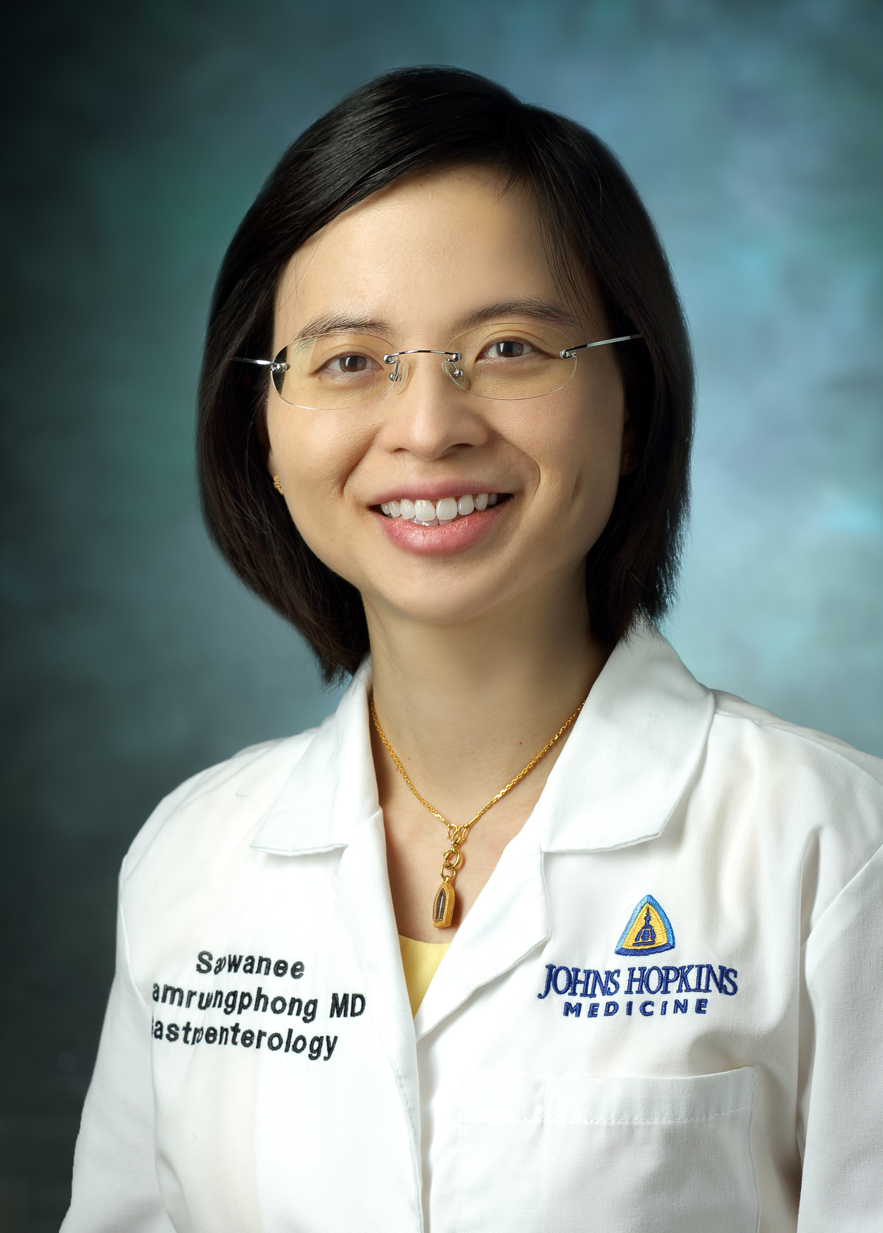 Dr. Saowanee Ngamruengphong in medical white coat and glasses