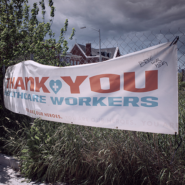 A white banner that says “thank you health care workers” is tied to a fence in Baltimore city.