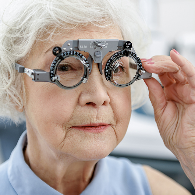 Photo of elderly woman testing her vision.