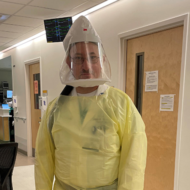 Photo of Martin Brodsky in yellow PPE