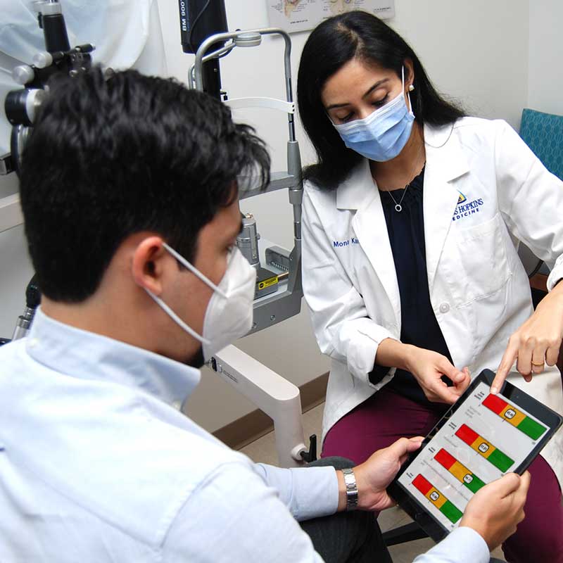 Mona Kaleem with a patient during an exam.