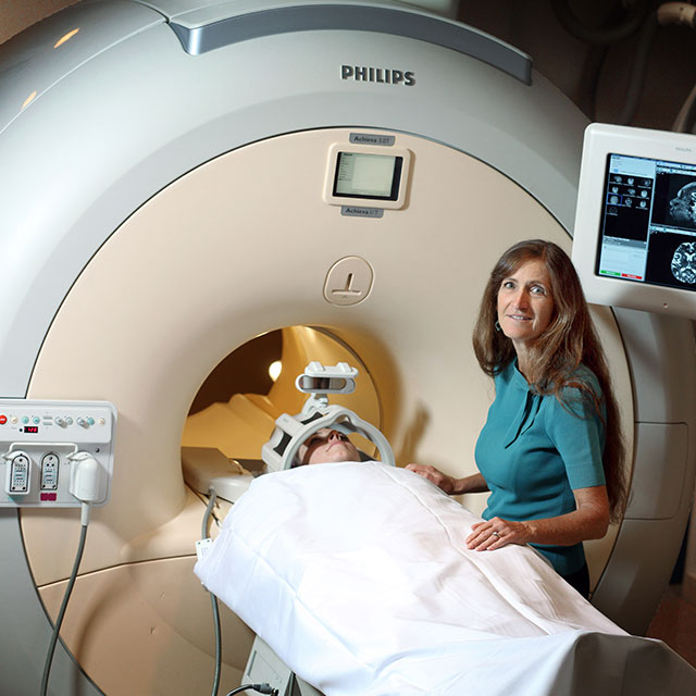 Neurologist Argye Hillis in front of MRI machine