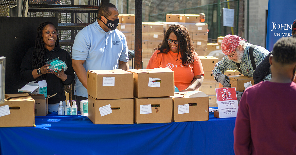 Members of the Mix Church and Johns Hopkins Government and Community Affairs staff assemble boxes of COVID-19 supplies.
