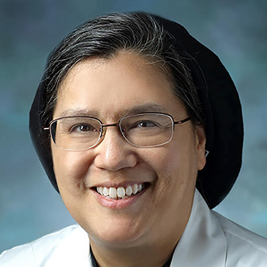 Robin Avery, in a formal portrait, wearing a white lab coat