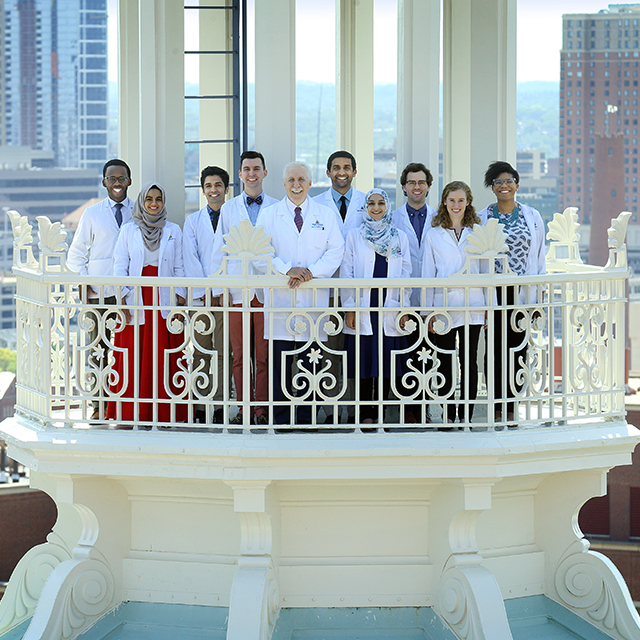 Rothman, with medical students in 2018, high atop the iconic Johns Hopkins Hospital dome.
