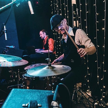 Jason Armstrong Baker Plays drums during a set.
