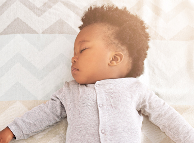 Baby sleeping safely in crib
