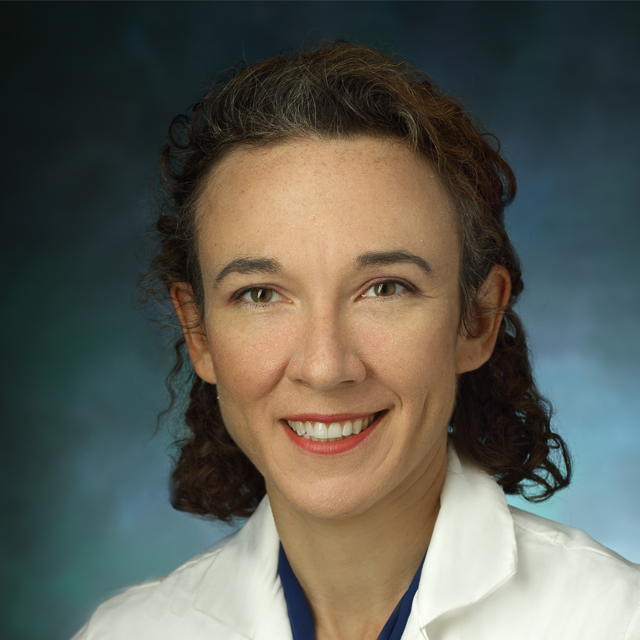 Head shot of Ada Graham, wearing a white coat. 
