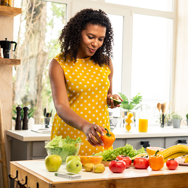 A woman organizing veggies on her counter.