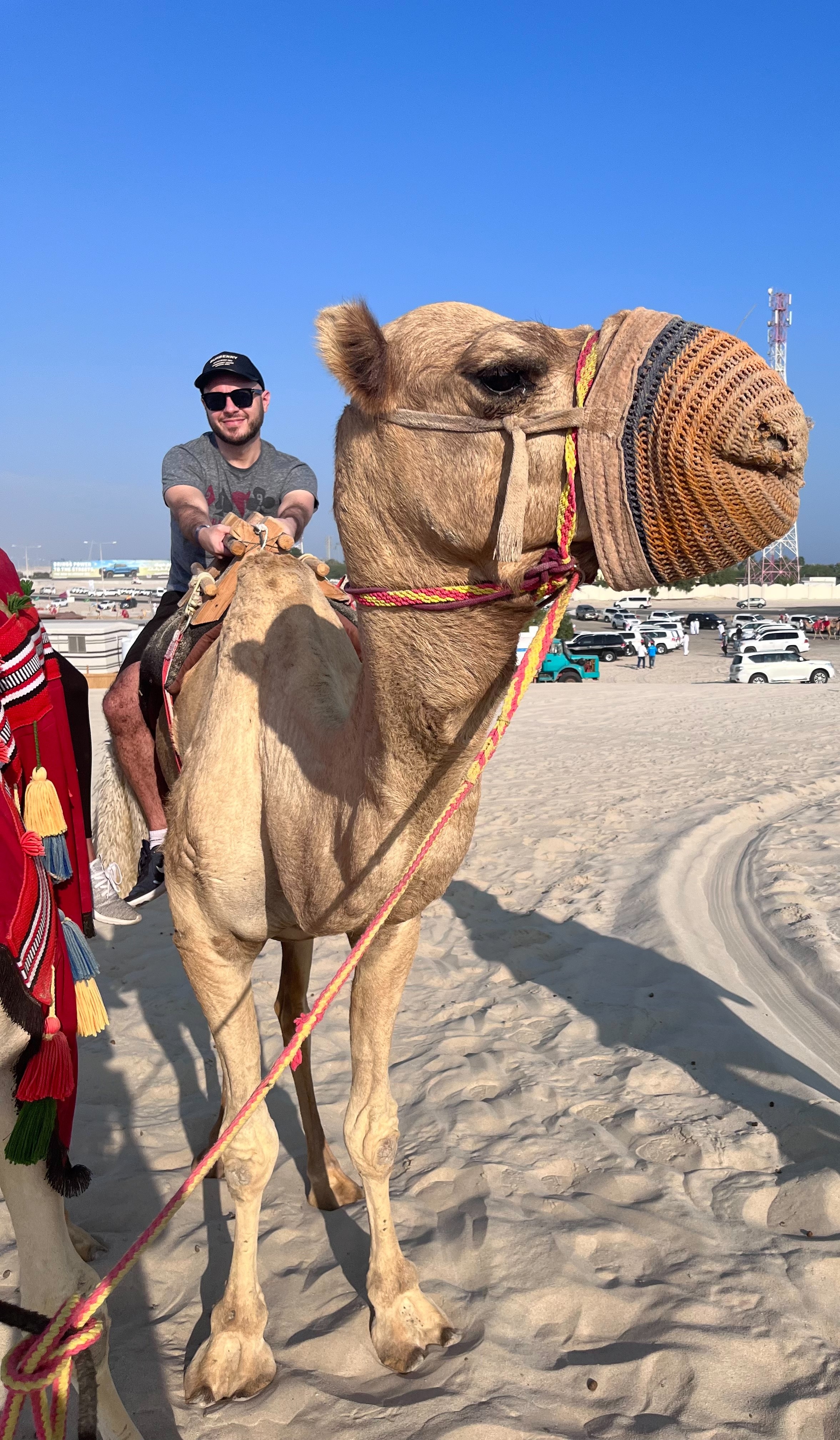 James Baisley on a camel in Doha