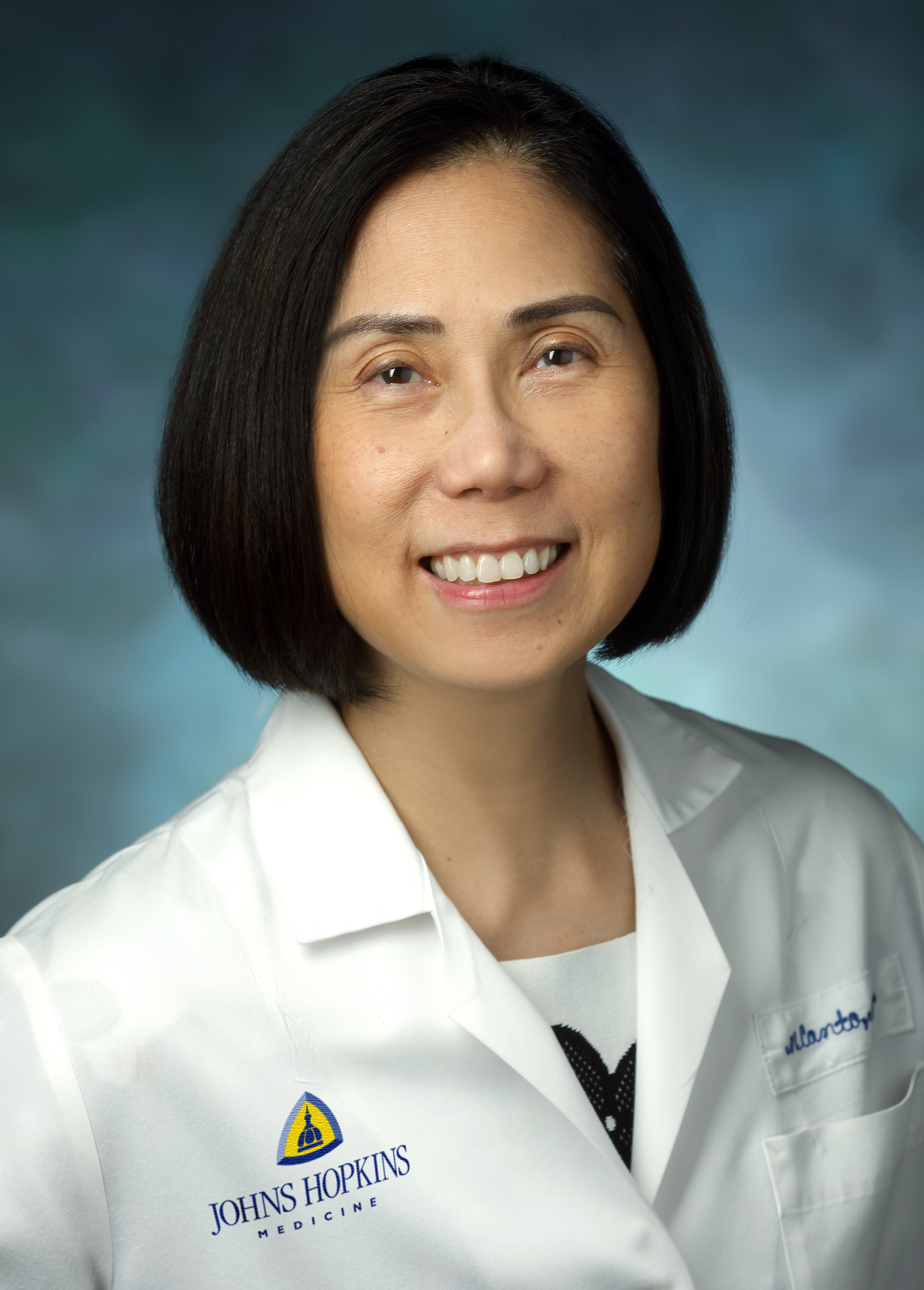 Portrait of Marcia Canto wearing white lab coat