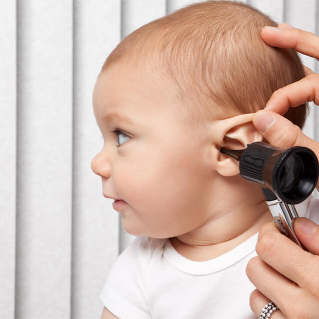 infant receives hearing screening test