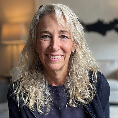 Photo of Karen Nitkin. She is smiling and wearing a black long sleeve.