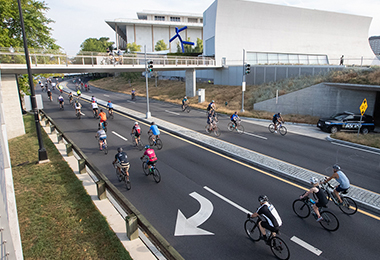 Bikers ride past the Kennedy Center in DC 