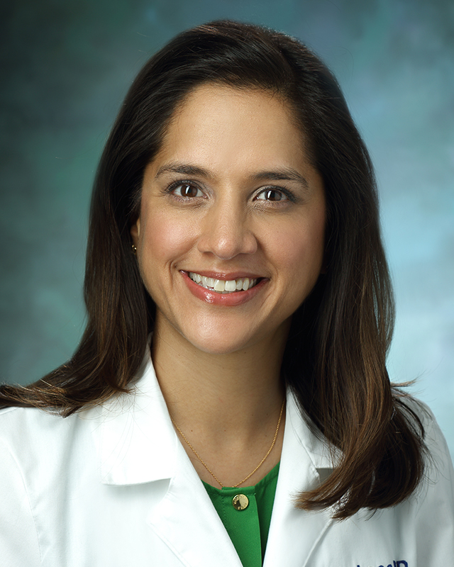 A portrait of Manisha J. Loss wearing her white coat