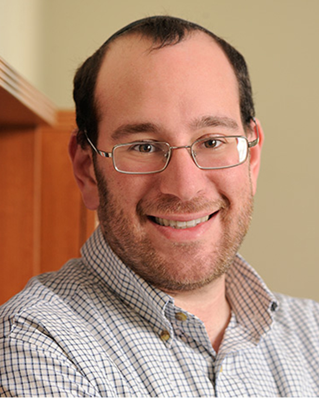 A photo of Mark Dredze smiling and wearing a collared shirt