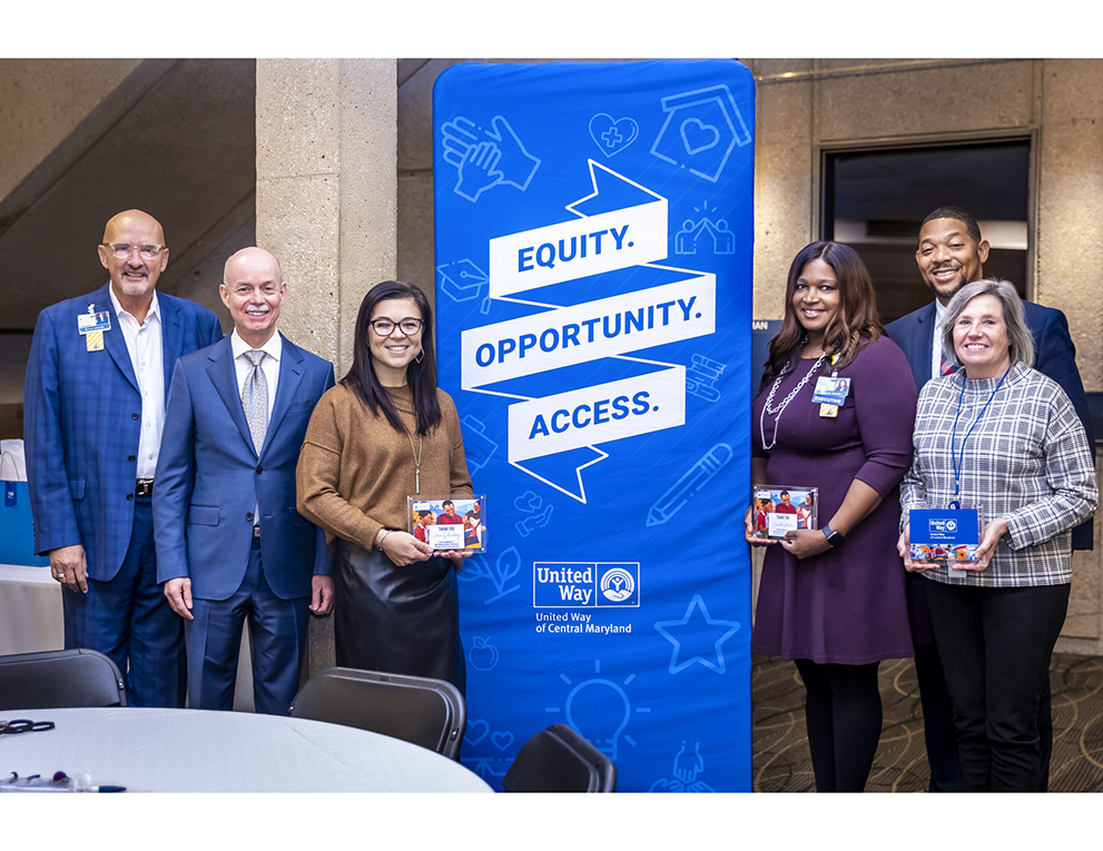 Johns Hopkins Interim Dean and CEO Theodore DeWeese and President and Executive Vice President Kevin Sowers join with Franklyn Baker, president and CEO of United Way of Central Maryland, and four Johns Hopkins United Way steering campaign award winners.