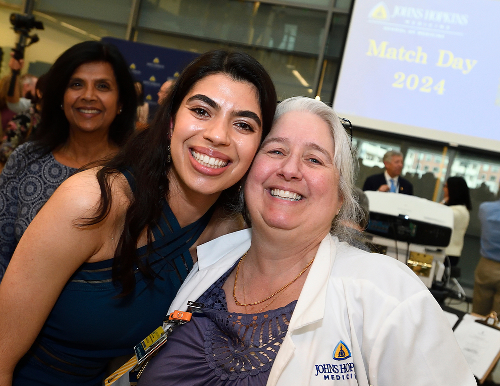 A female med student takes a selfie with an older woman.
