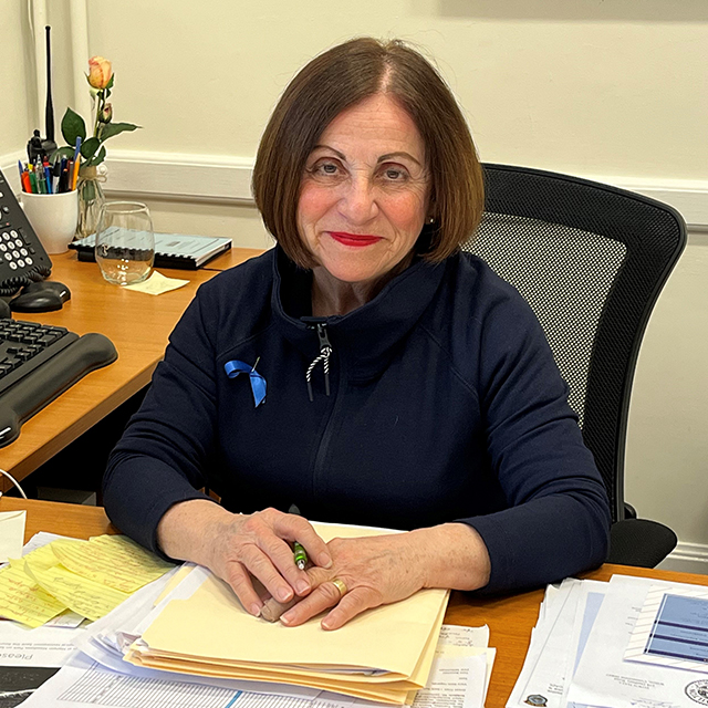 Toni Boucher sits smiling at her desk