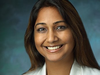 Dr. Galaiya smiles in her portrait