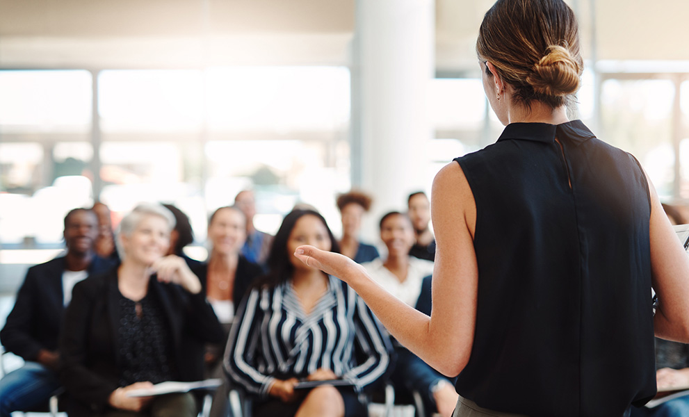 Shot of a young businesswoman delivering a speech during a conference