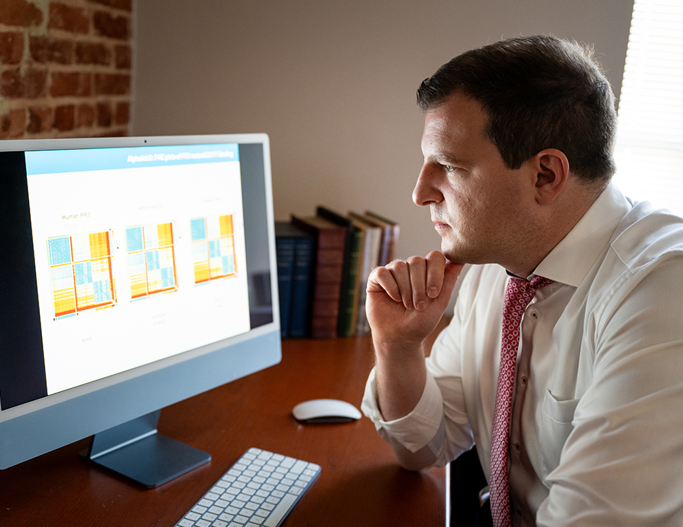 Maximilian Konig looks at his research on a computer screen
