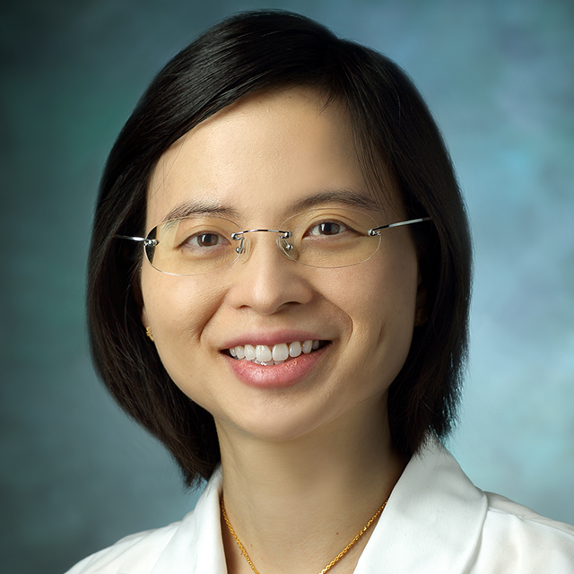 Dr. NGAMRUENGPHONG smiles against a plain background.