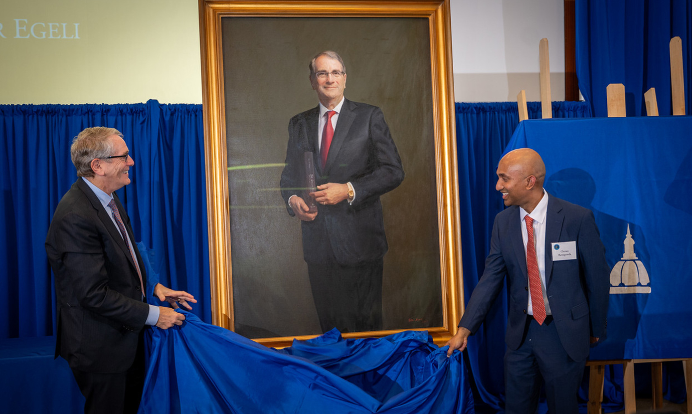 Henry Brem, left, and Chetan Bettegowda unveil a portrait of Dr. Brem
