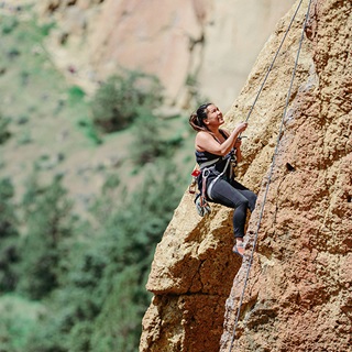 Woman rock climbing outside