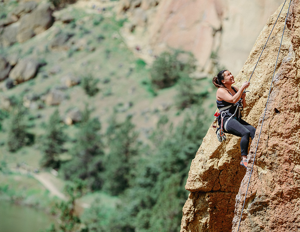 Woman rock climbing outside