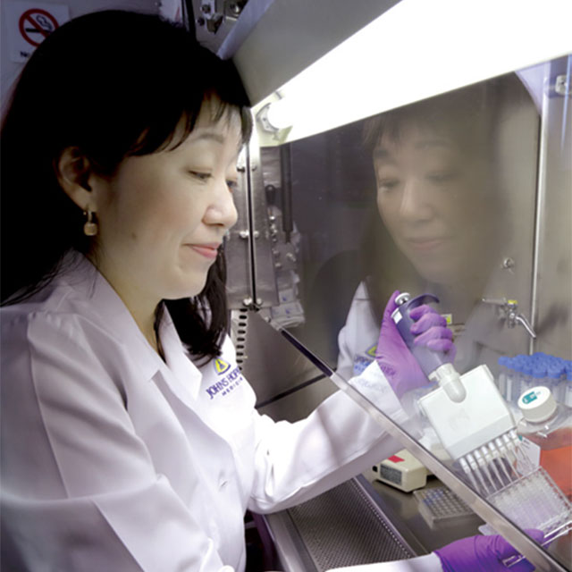 Researcher using a multi-pipette in the lab.