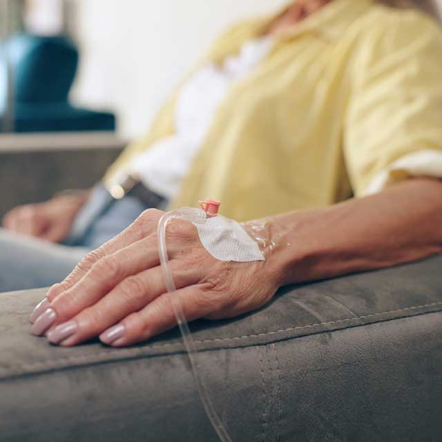 Older man receiving infusion medicine at home