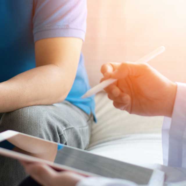 Provider speaking to patient about options while holding a patient