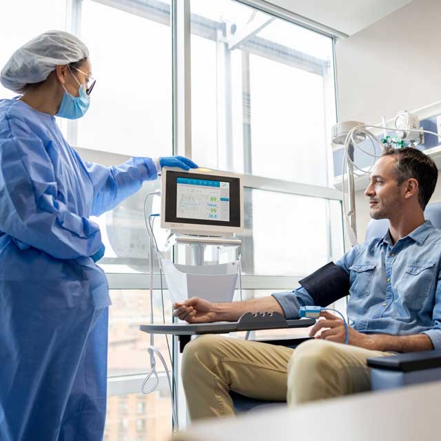 Provider monitors the heart rate of their cancer patient