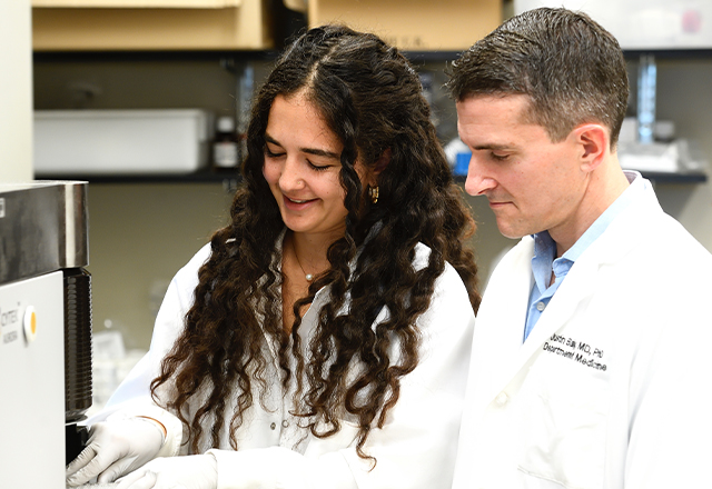 Ariadne Sinnis-Bourozikas, left, pictured here with infectious diseases professor Justin Bailey, is pursuing research into better treatments for hepatitis B.