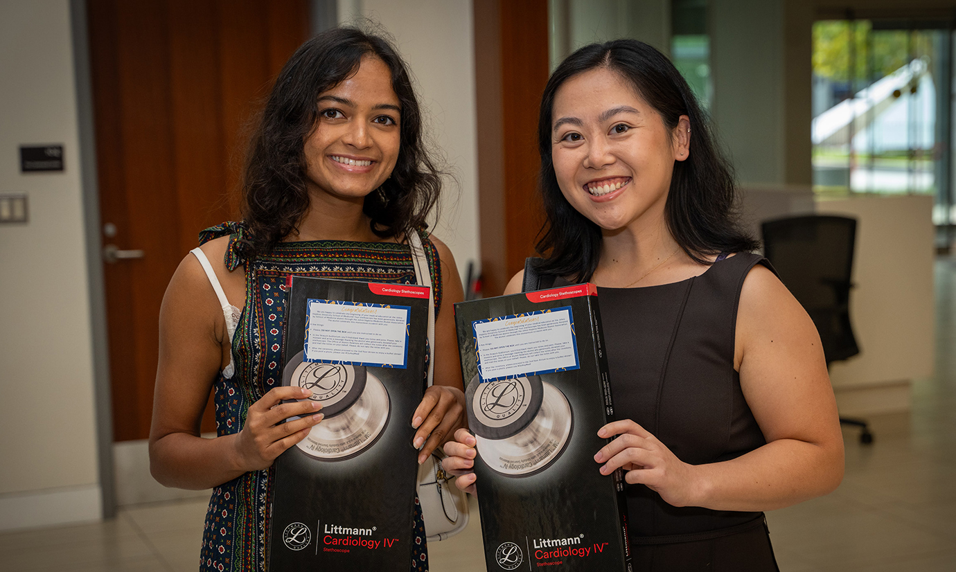 Two doctors pose for the white coat ceremony