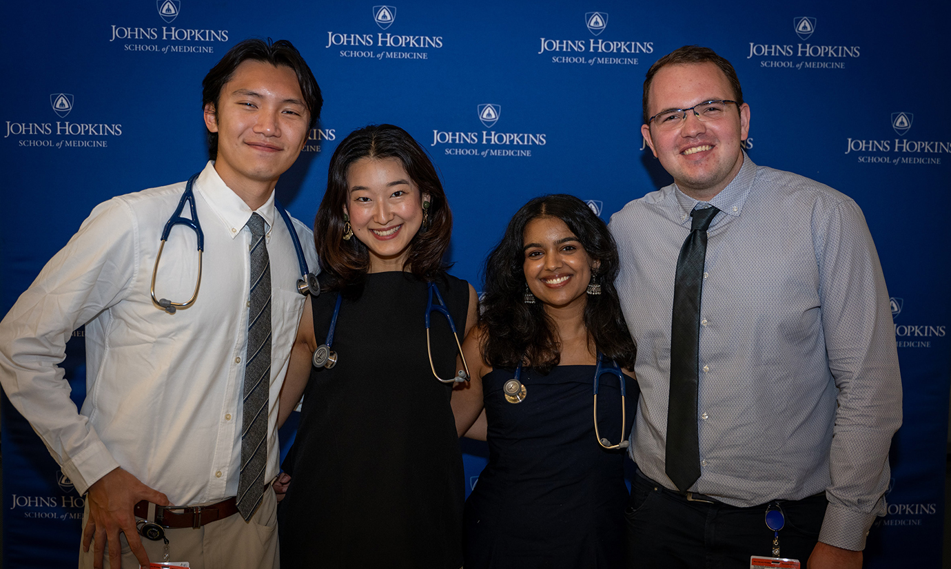 Four doctors pose from the white coat ceremony
