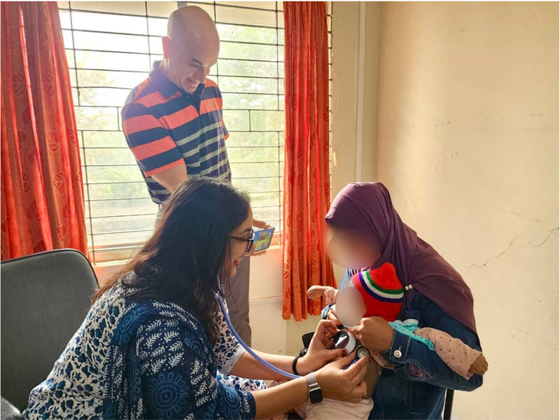 Eric McCollum and Sunaina Kapoor examine a patient