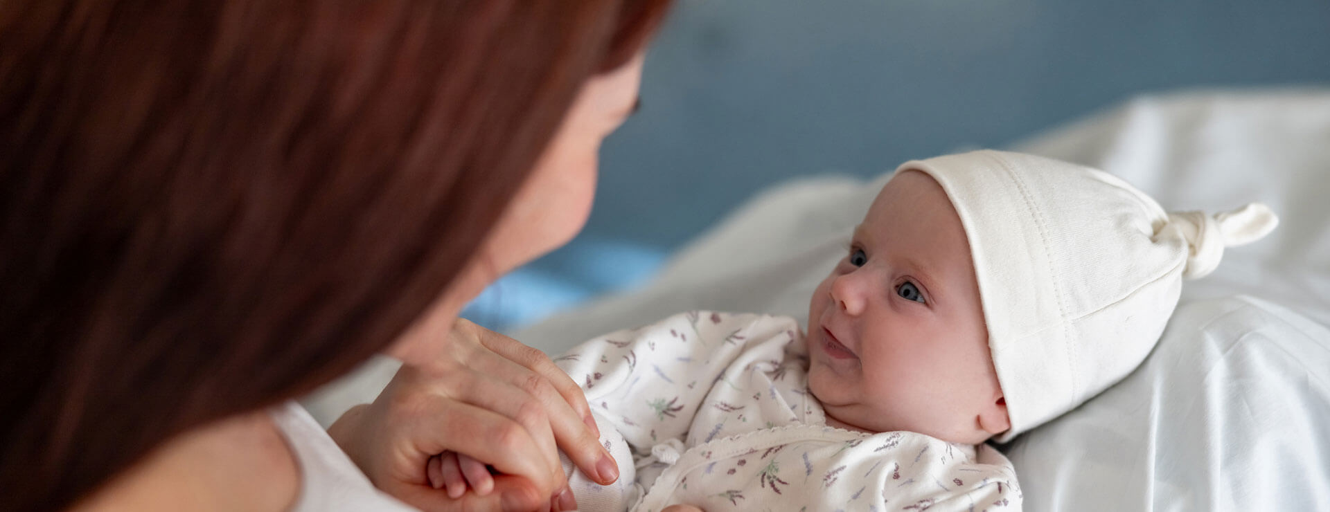 Smiling infant in hospital bed
