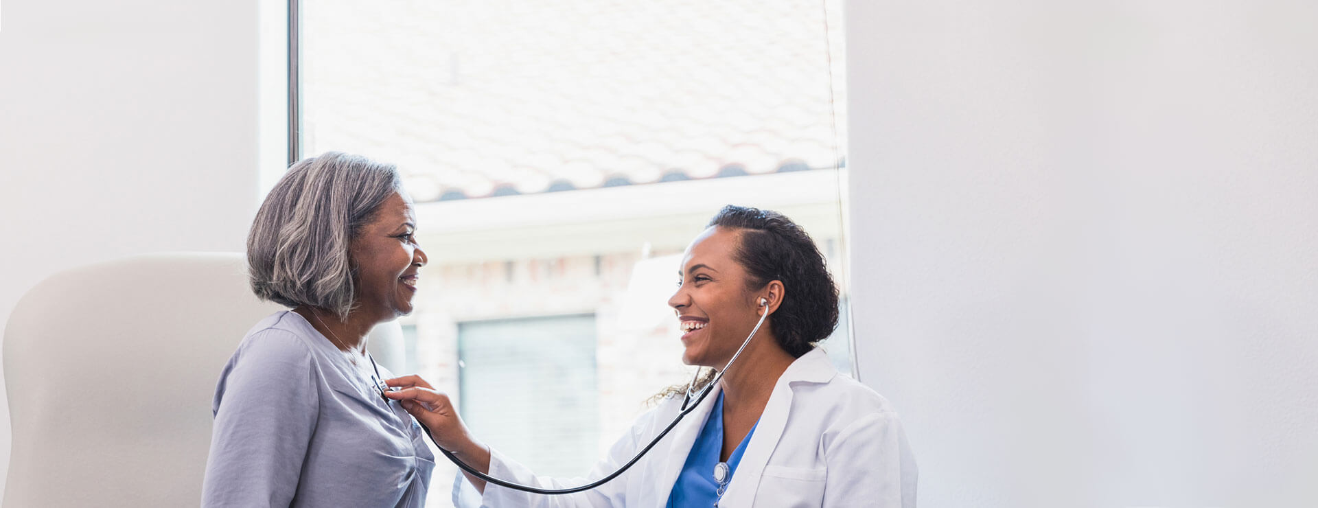 doctor listens to patients heart