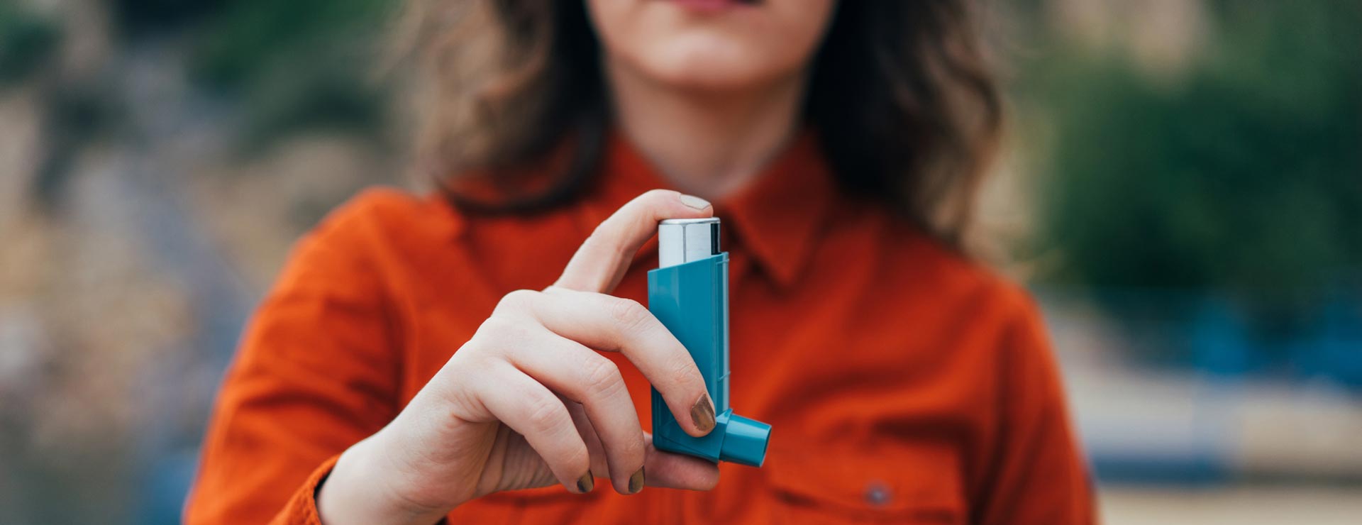 Woman holding an asthma inhaler