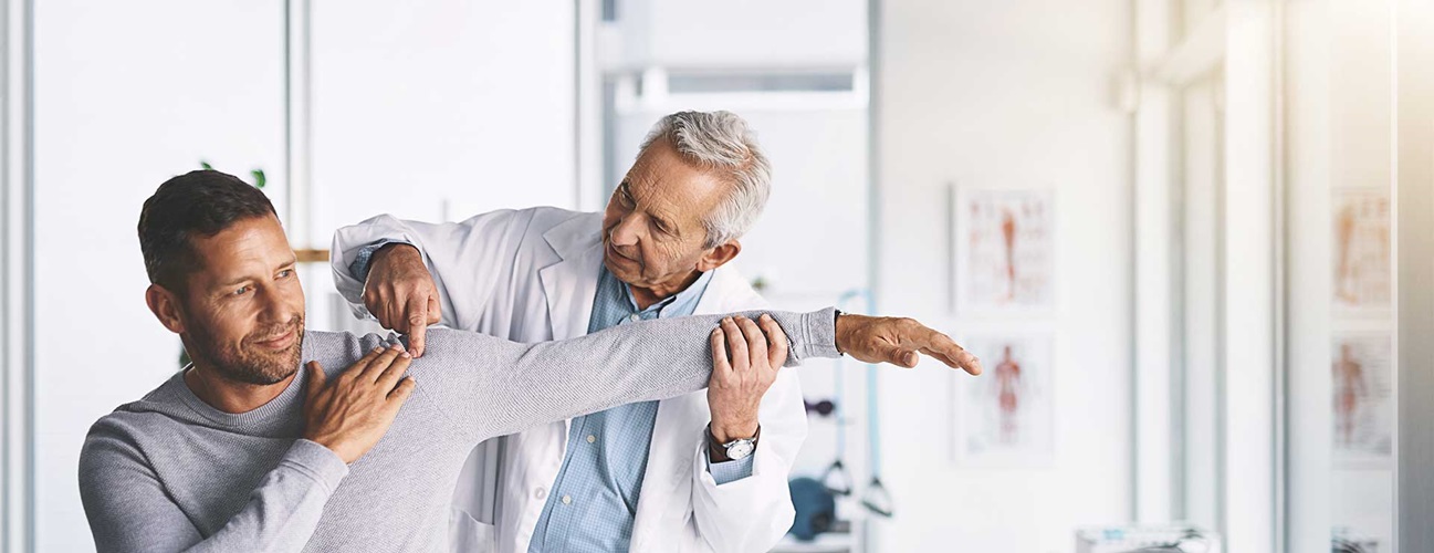 a doctor checks the shoulder and arm joints of male patients