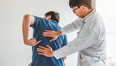 Spine doctor consulting with patient about back problems