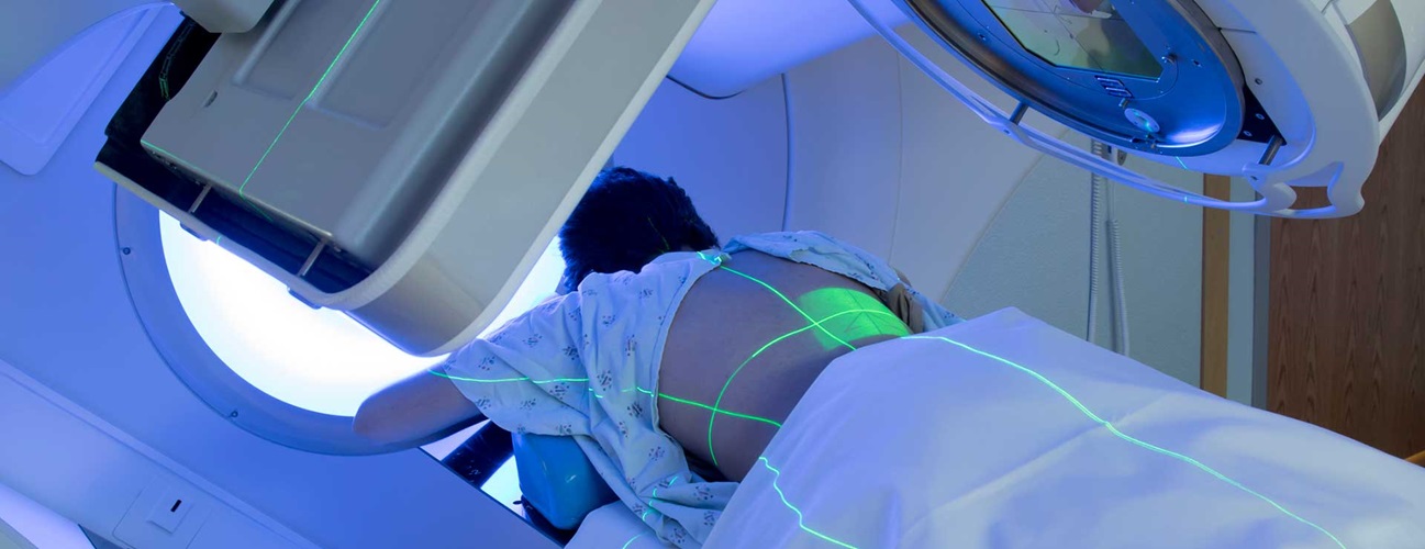 Woman undergoing radiation therapy for her back