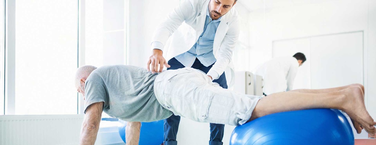 Senior man in physical therapy for back pain