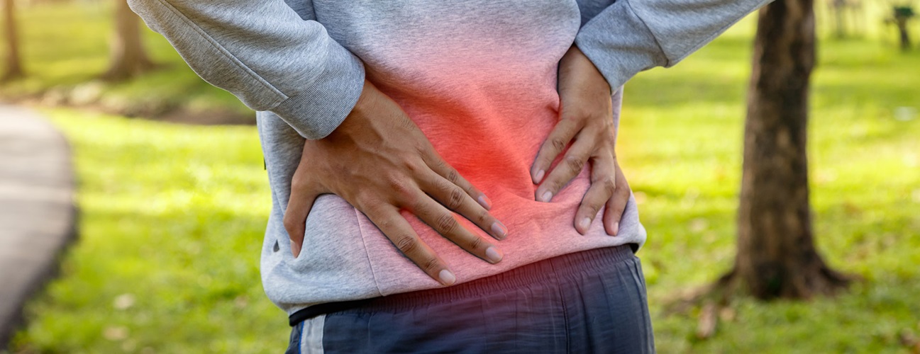A man's lower back radiates with pain.