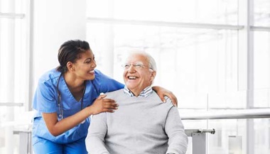 doctor smiling at older male patient