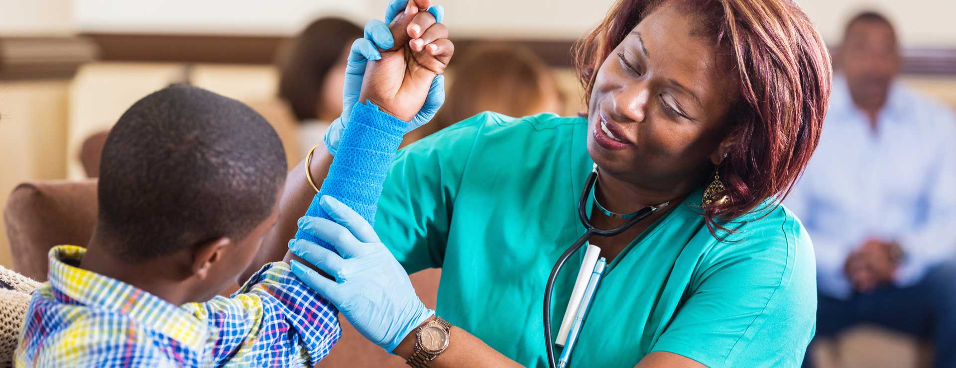 Nurse examining a child's arm in a cast.
