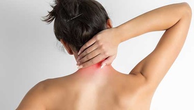 woman holding her painful neck with the right hand